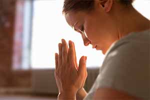 close up of woman meditating at yoga studio